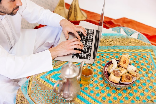 man learning Quran online